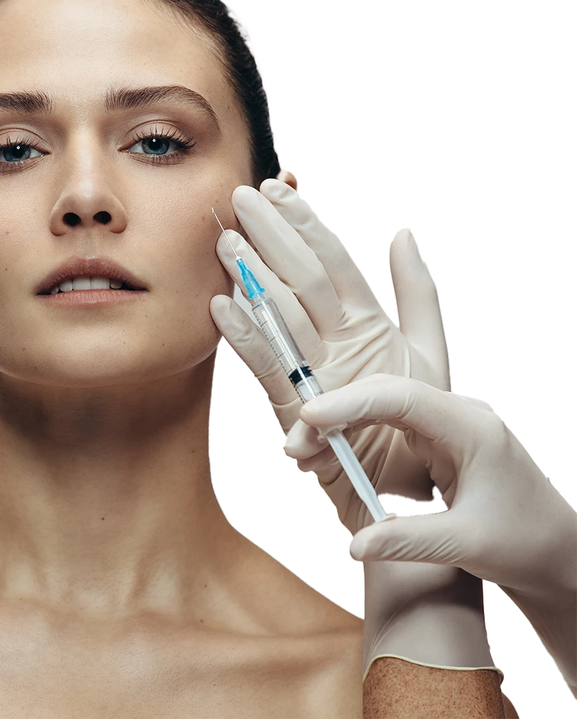 Close-up of a woman receiving a cosmetic injection in her cheek. The practitioner, wearing white gloves, carefully administers the treatment using a syringe, focusing on precision and care. The woman has clear, smooth skin and an expression of calmness, highlighting the professional and delicate nature of the procedure.
